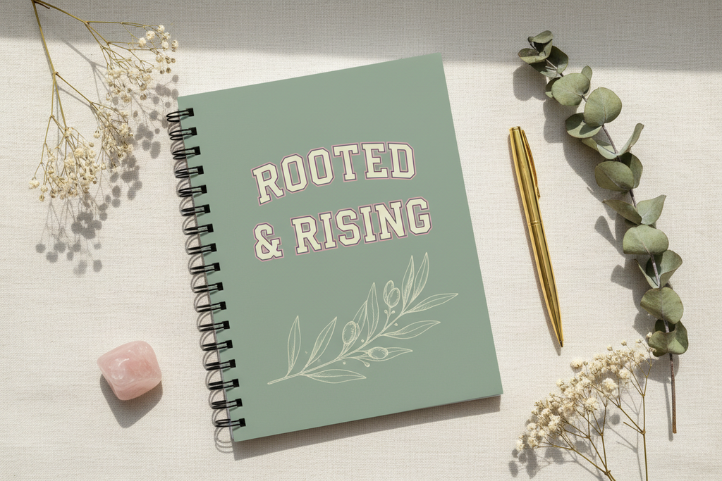 ROOTED & RISING sage green spiral notebook flat lay on cream linen with eucalyptus and rose quartz